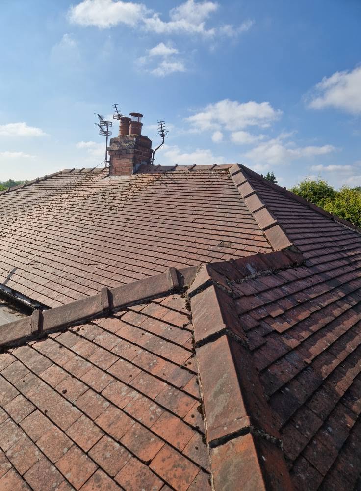 Ridge and chimney repairs on a clay tile roof